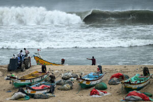 Fishermen securing boats and moving inland ahead of Cyclone Montha near Andhra and Odisha coastal areas.