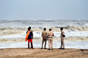 Police and disaster response teams patrolling Andhra beaches to prevent fishermen from venturing into the sea during Cyclone Montha alert.