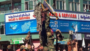 Afghan Taliban fighters display pants of Pakistani soldiers who allegedly fled their posts during the border clashes