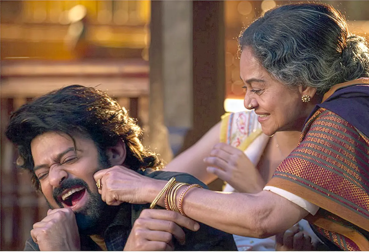 The Raja Saab Telugu movie VIDHAATHA review featuring Prabhas in a fun, emotional moment with Zarina Wahab as grandmother pulling his cheeks.