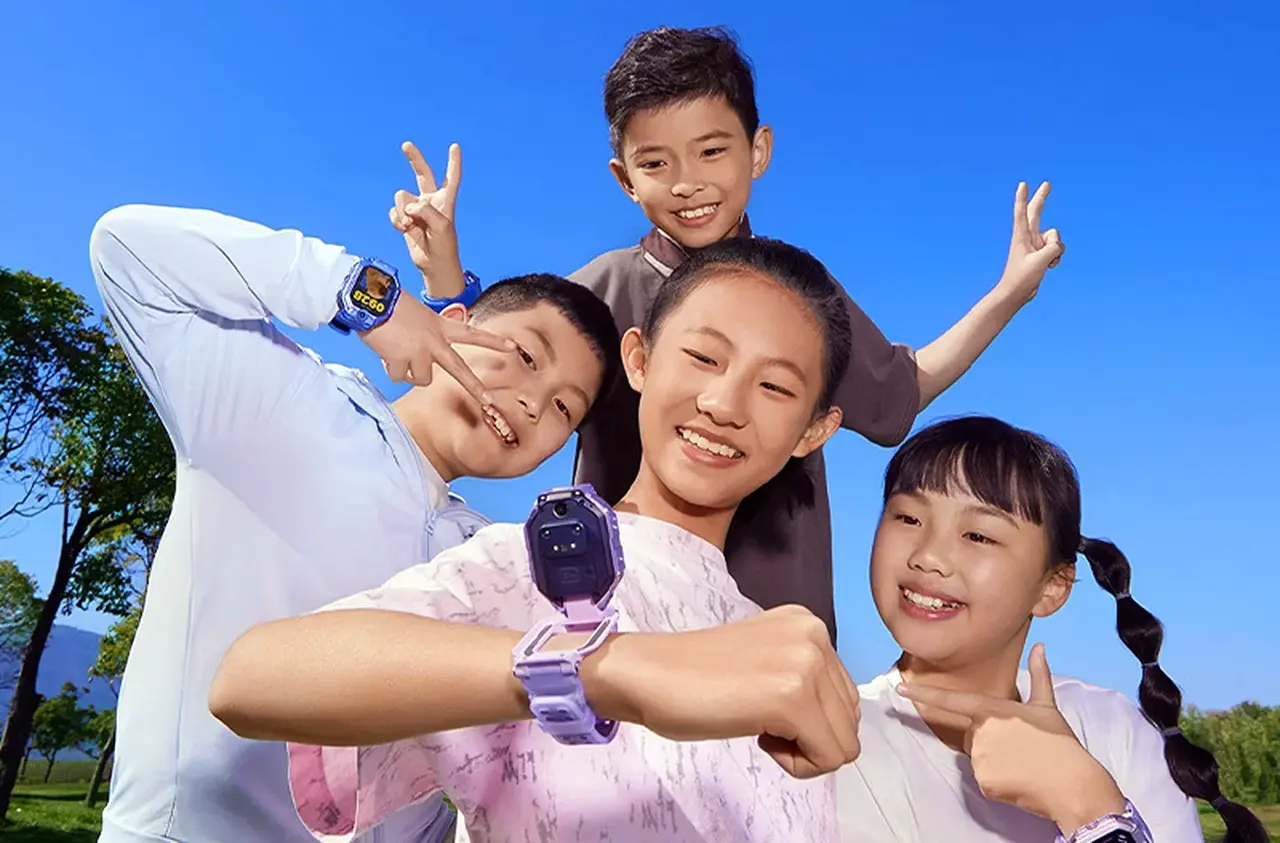 Children wearing Xiaomi Kids Watch while checking time and posing happily outdoors