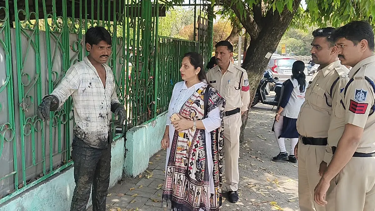 Indore police and Women & Child Development officials interacting with a man during an anti-beggary enforcement drive.