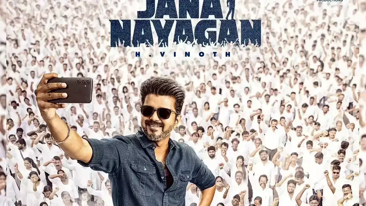 Actor Vijay in Jana Nayagan movie poster taking a selfie with a huge cheering crowd in the background