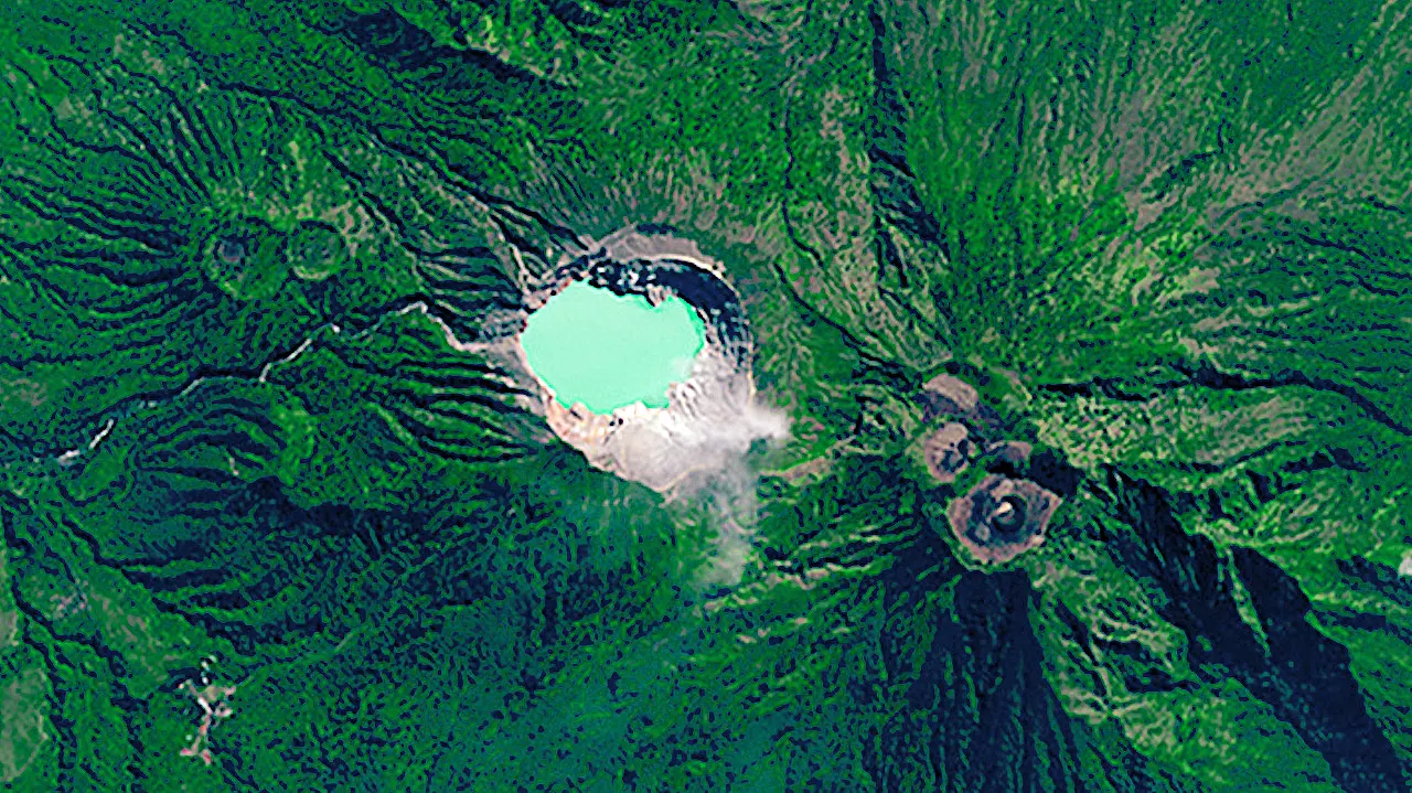 Satellite view of Kawah Ijen volcanic crater with bright turquoise acidic lake surrounded by rugged green mountains