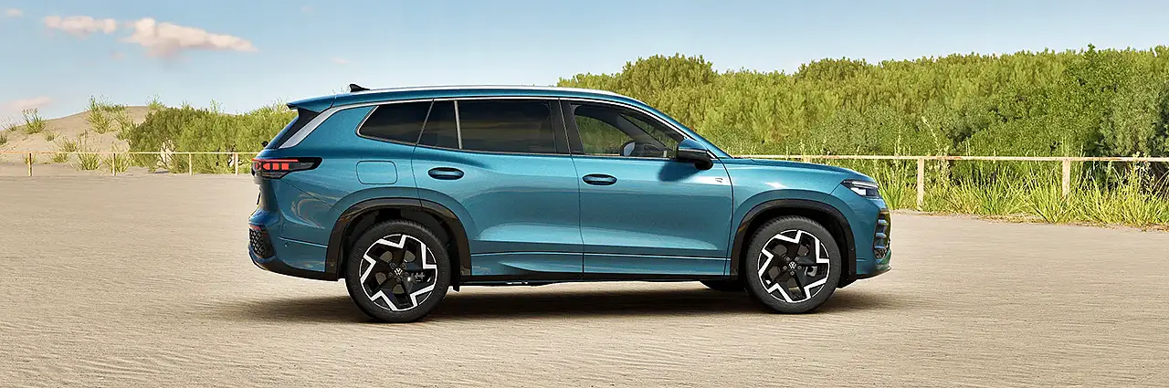 Volkswagen Tayron R-Line side profile blue color SUV on road premium design India launch