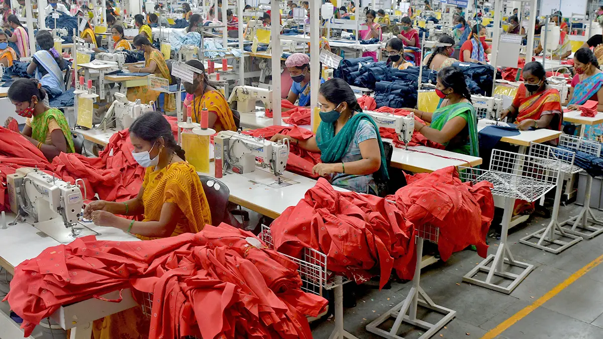 Workers stitching garments in textile factory showing employment boost from India–EU free trade agreement