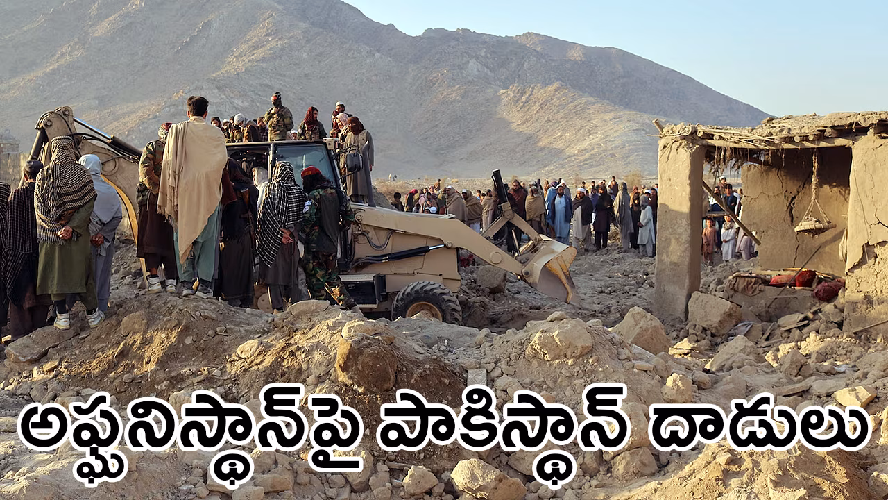 Crowd searching through debris of collapsed buildings after overnight air strikes near Pakistan border