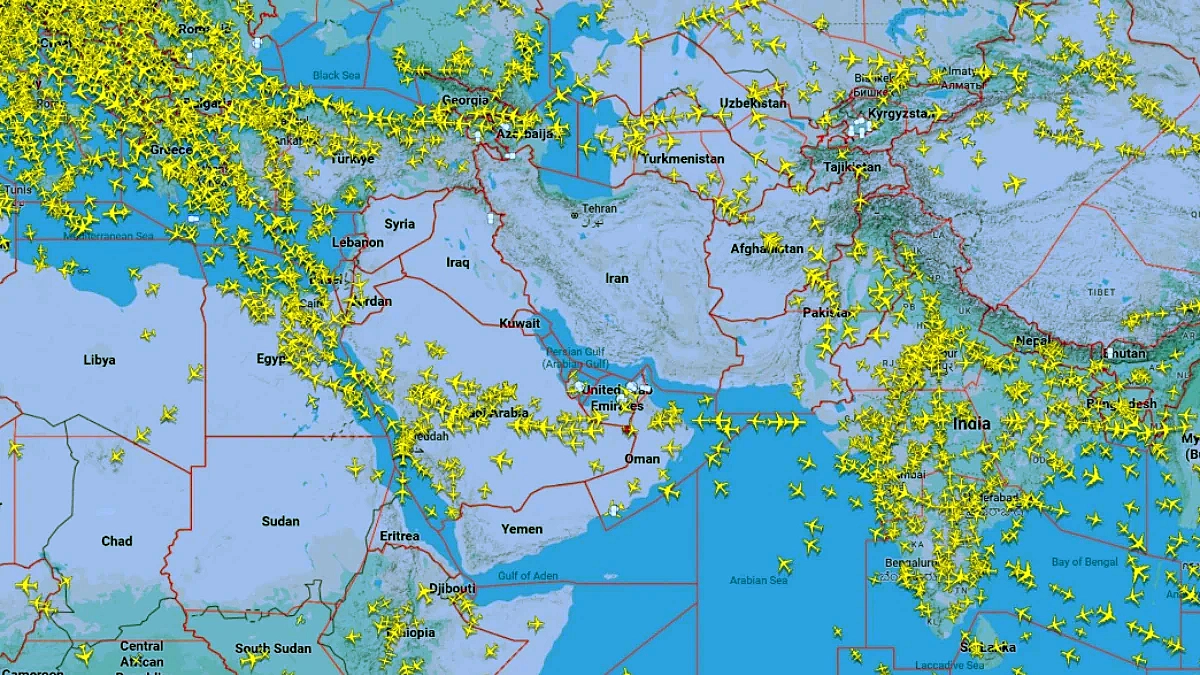 Wide-view Flightradar24 live air traffic map covering Europe, Middle East, Central Asia, and India. Dense clusters of yellow airplane icons over Turkey, Saudi Arabia, Egypt, India, and Europe, but a large empty blank zone over Iran, Iraq, and parts of the Persian Gulf, with flights rerouted around the closed airspace following US-Israel strikes on Iran.