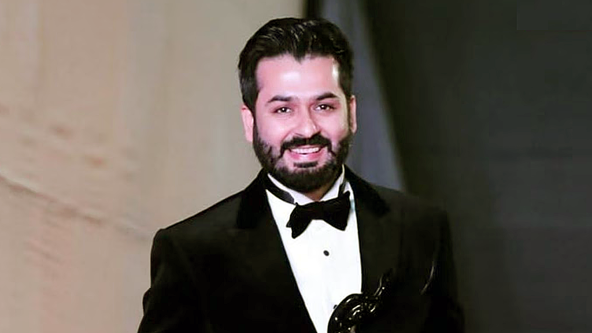 Aditya Dhar director of Dhurandhar The Revenge in formal suit at event showcasing filmmaker behind patriotic action drama