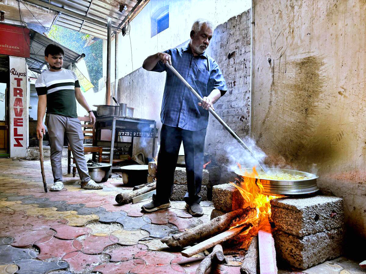 Hotel staff cooking meals using firewood amid gas shortage