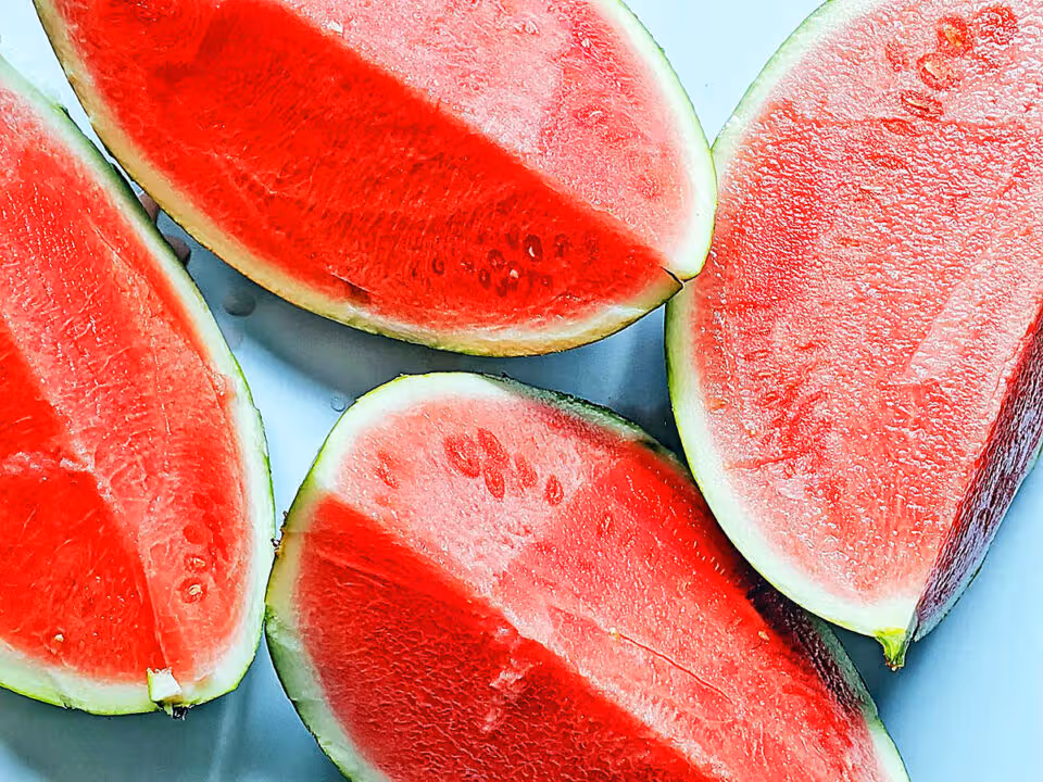 Fresh sliced watermelon pieces arranged on plate showing juicy red fruit for summer health story