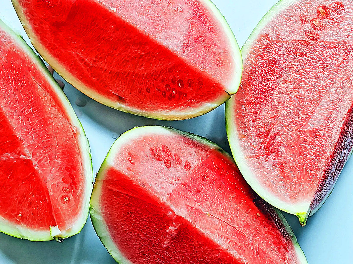 Fresh sliced watermelon pieces arranged on plate showing juicy red fruit for summer health story