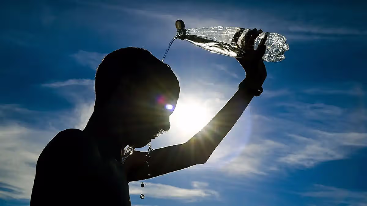 Person cooling down with water during extreme heatwave in India