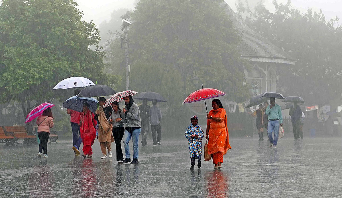 Vehicles move through waterlogged road in Hyderabad during heavy rainfall
