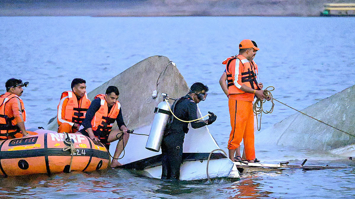 Divers working near submerged cruise wreckage in Bargi Dam waters