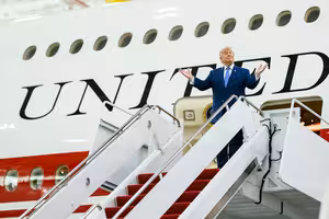 Donald Trump standing on the stairs of the new Air Force One aircraft